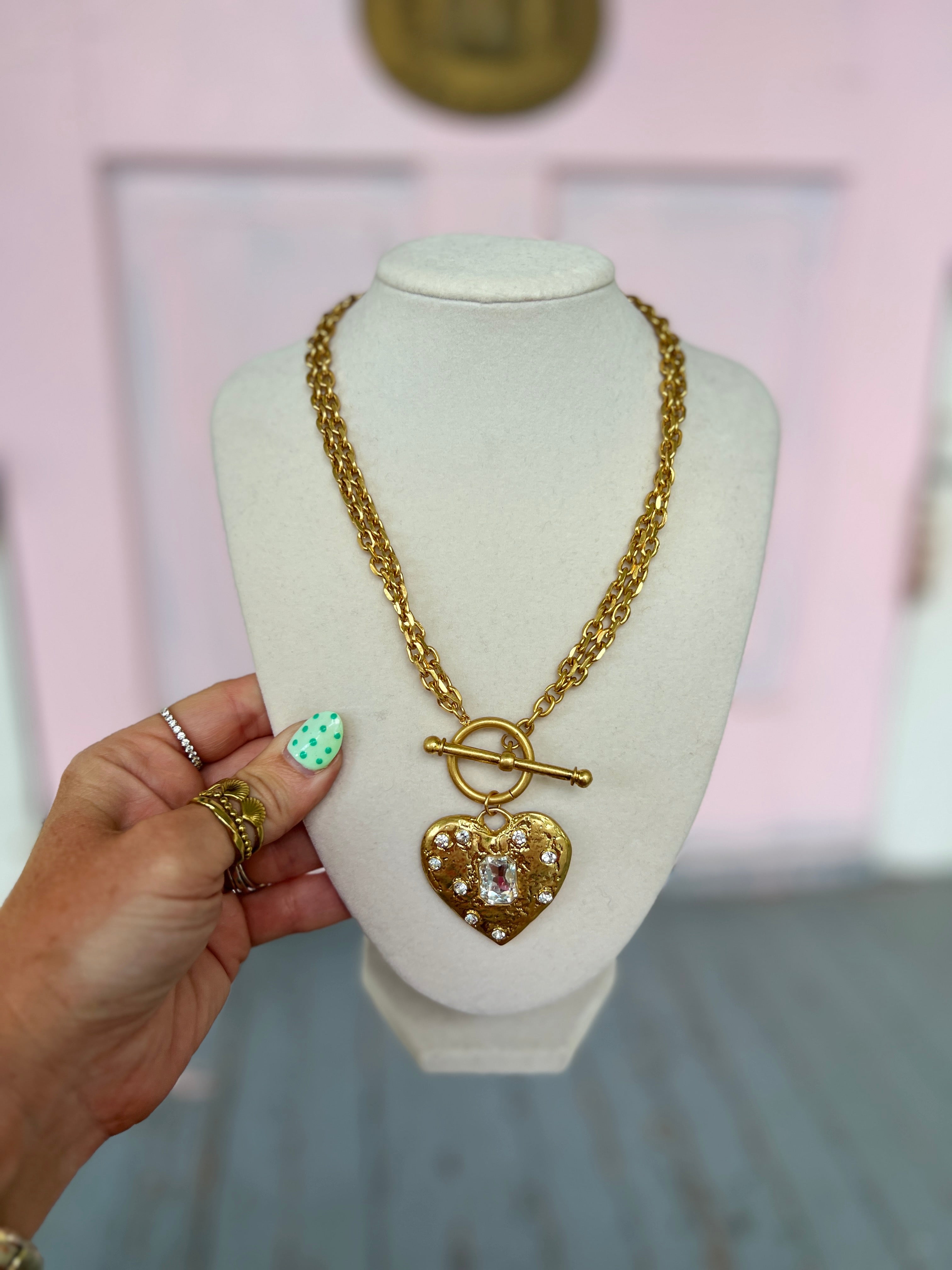 Gold-tone layered necklace set with heart pendant and small stone accents