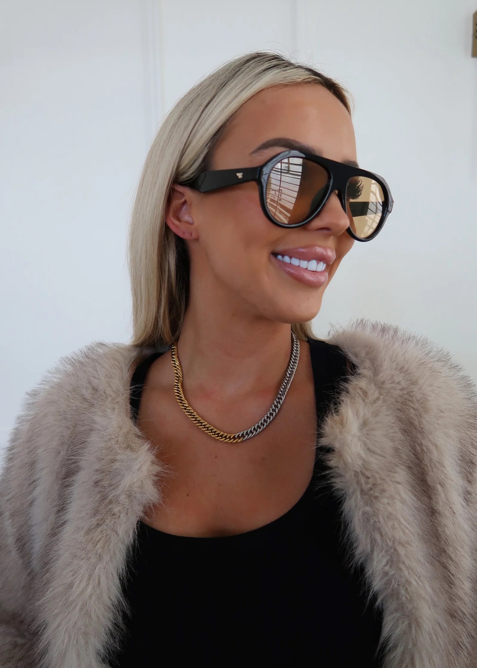 Two-tone chain necklace with gold and silver link rows, close around neck