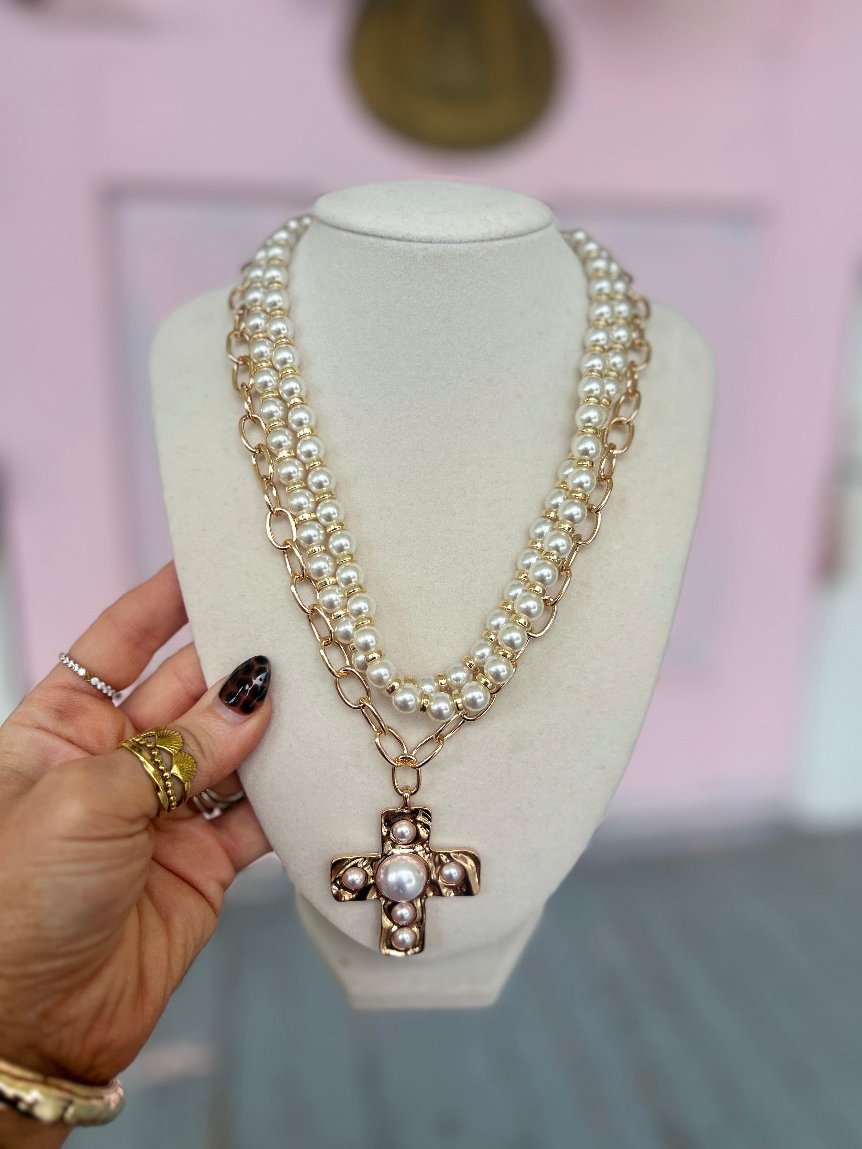 Layered pearl cross necklace set with gold-tone chains and pearl cross pendant