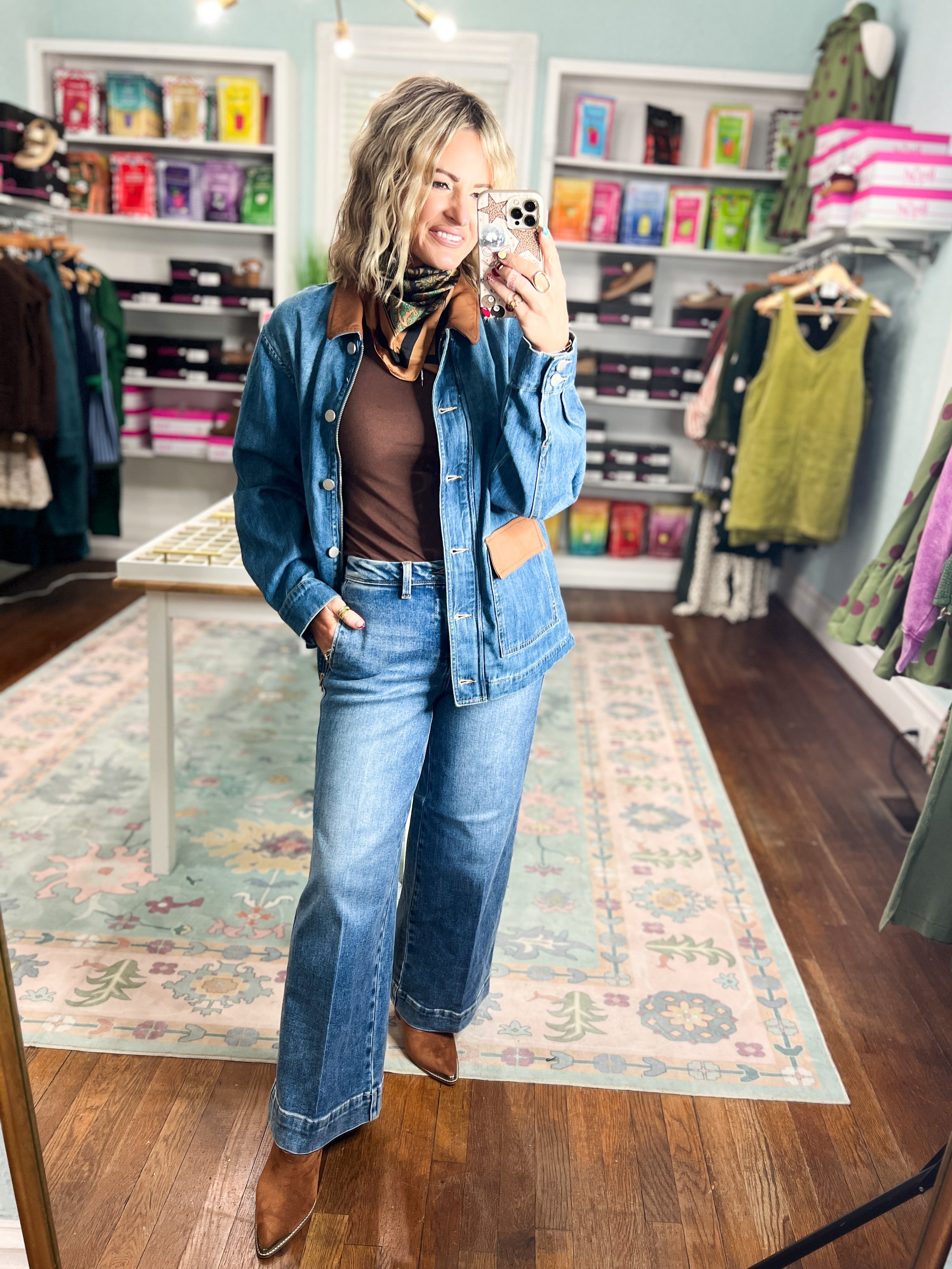 Medium-wash denim jacket with brown leather contrast collar, oversized denim top, button front