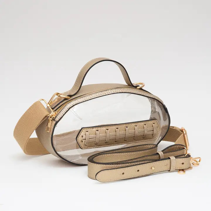 Clear football-shaped stadium bag with tan strap and gold-tone hardware