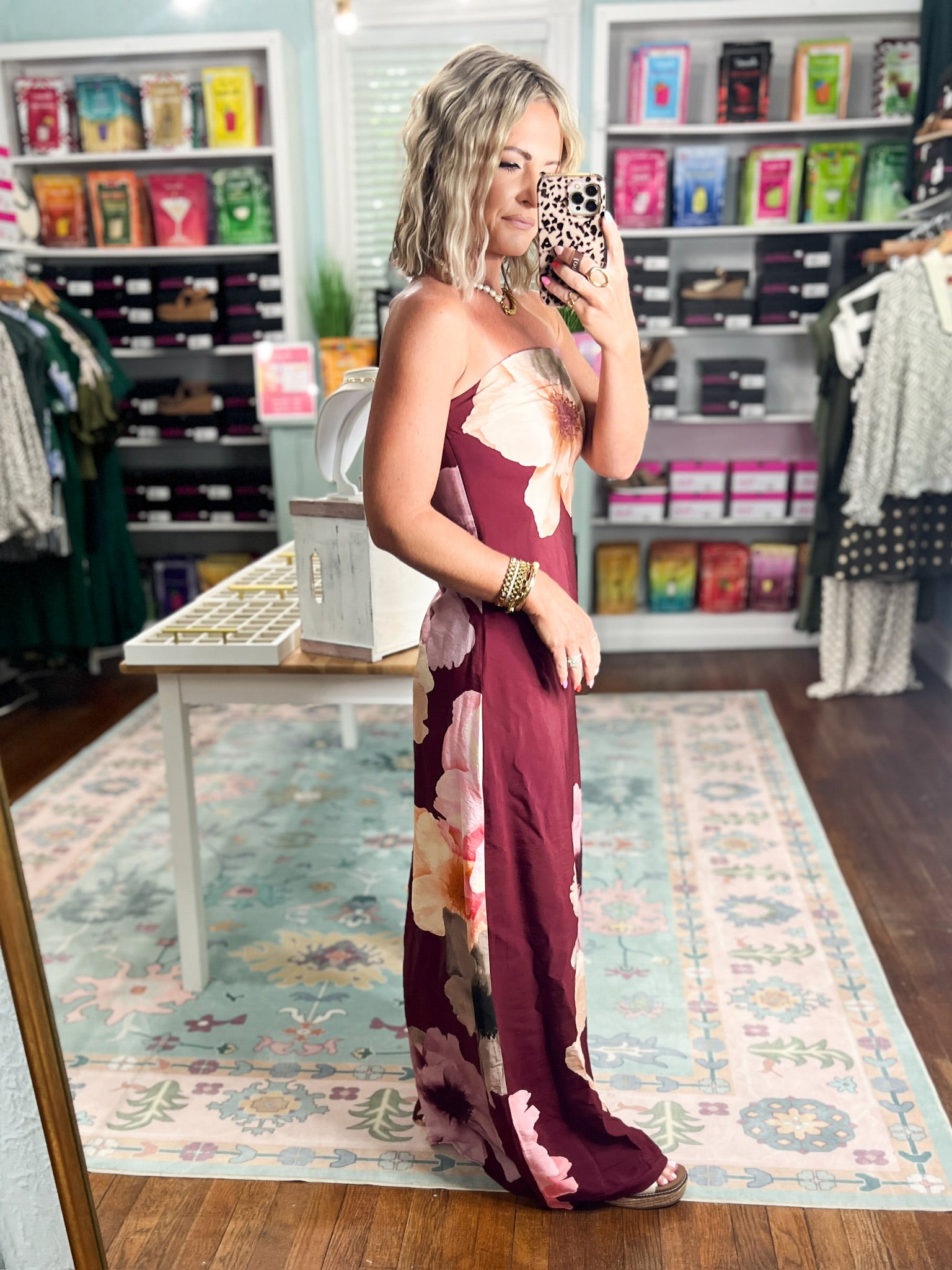 Burgundy strapless maxi dress in profile, cream and pink floral print with long fitted hem