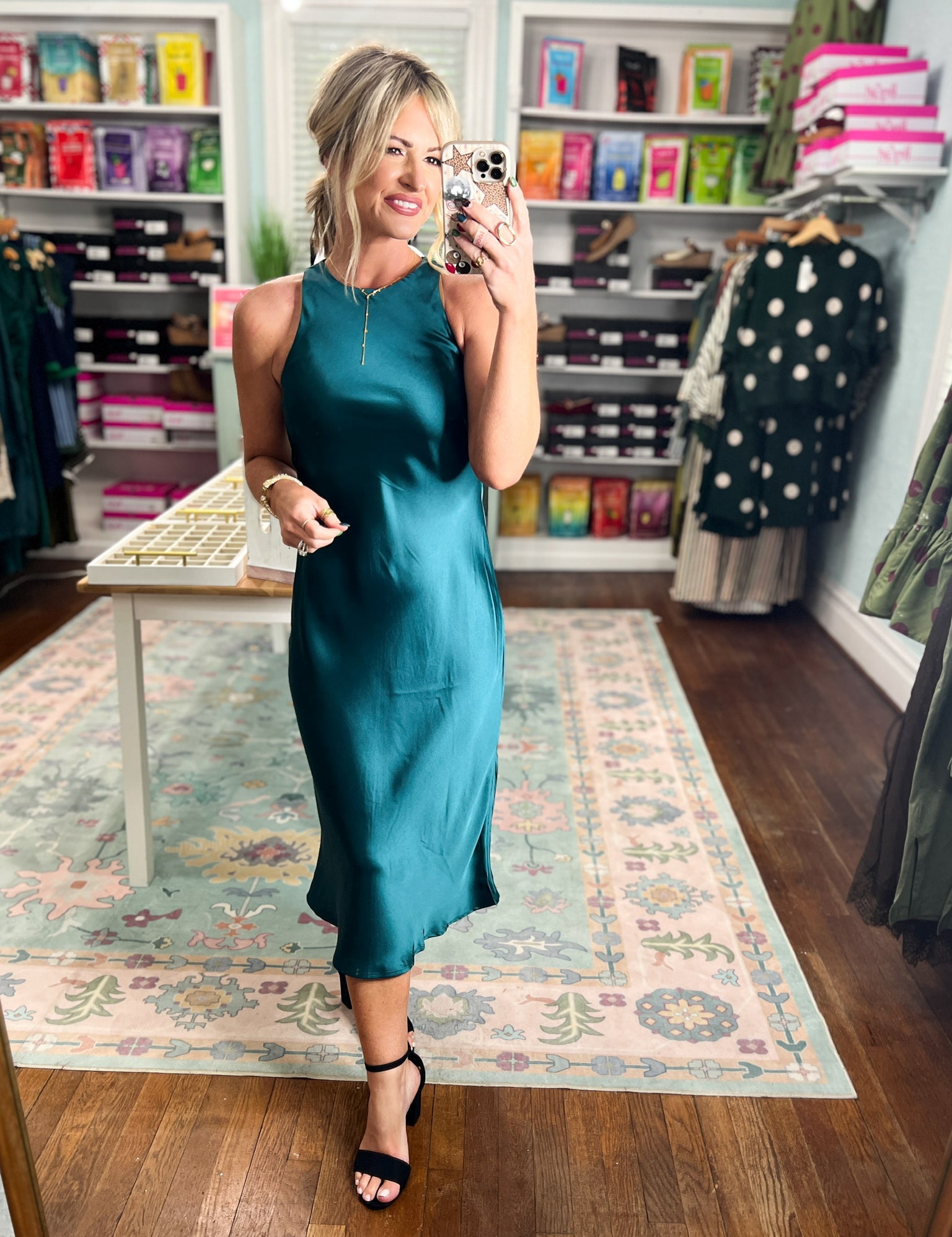 Dark teal satin midi dress, sleeveless with high neckline and glossy satin finish.
