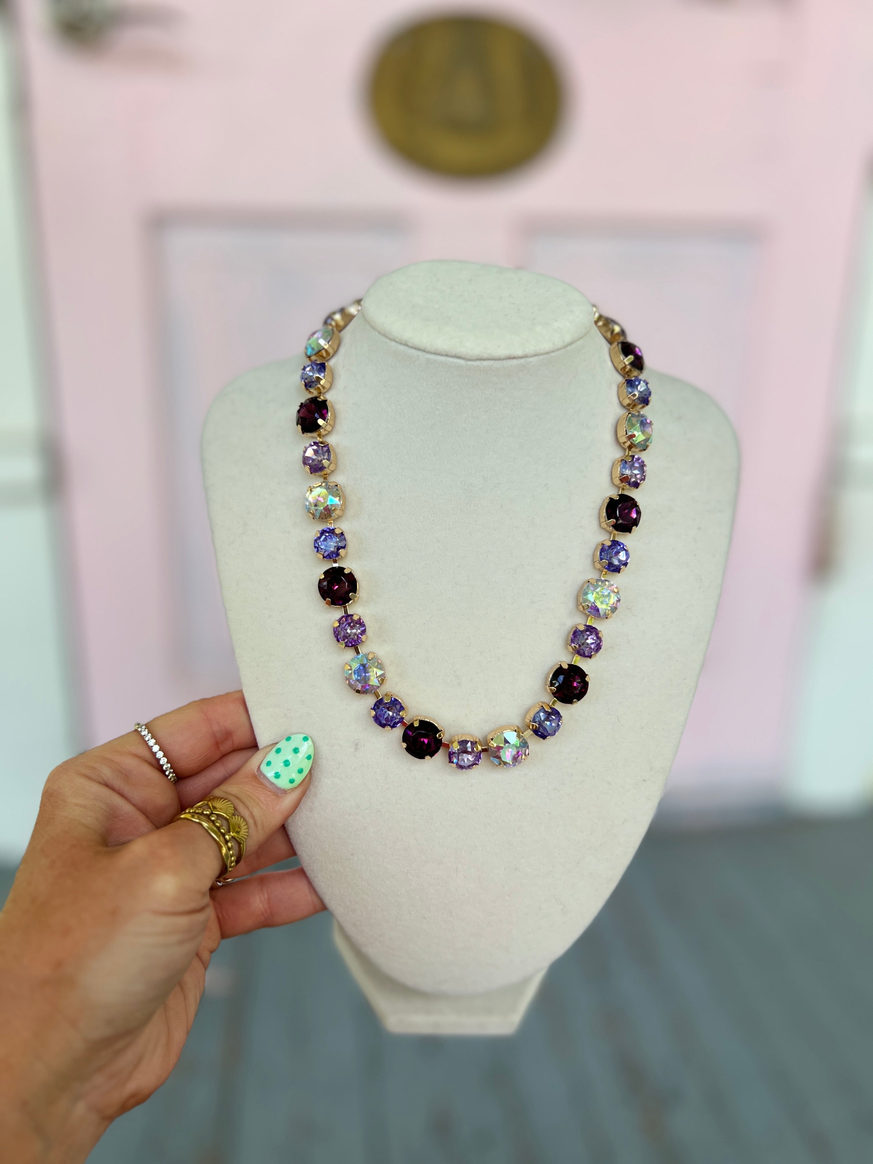 Purple and gold glass-stone bead magnetic necklace on bust display