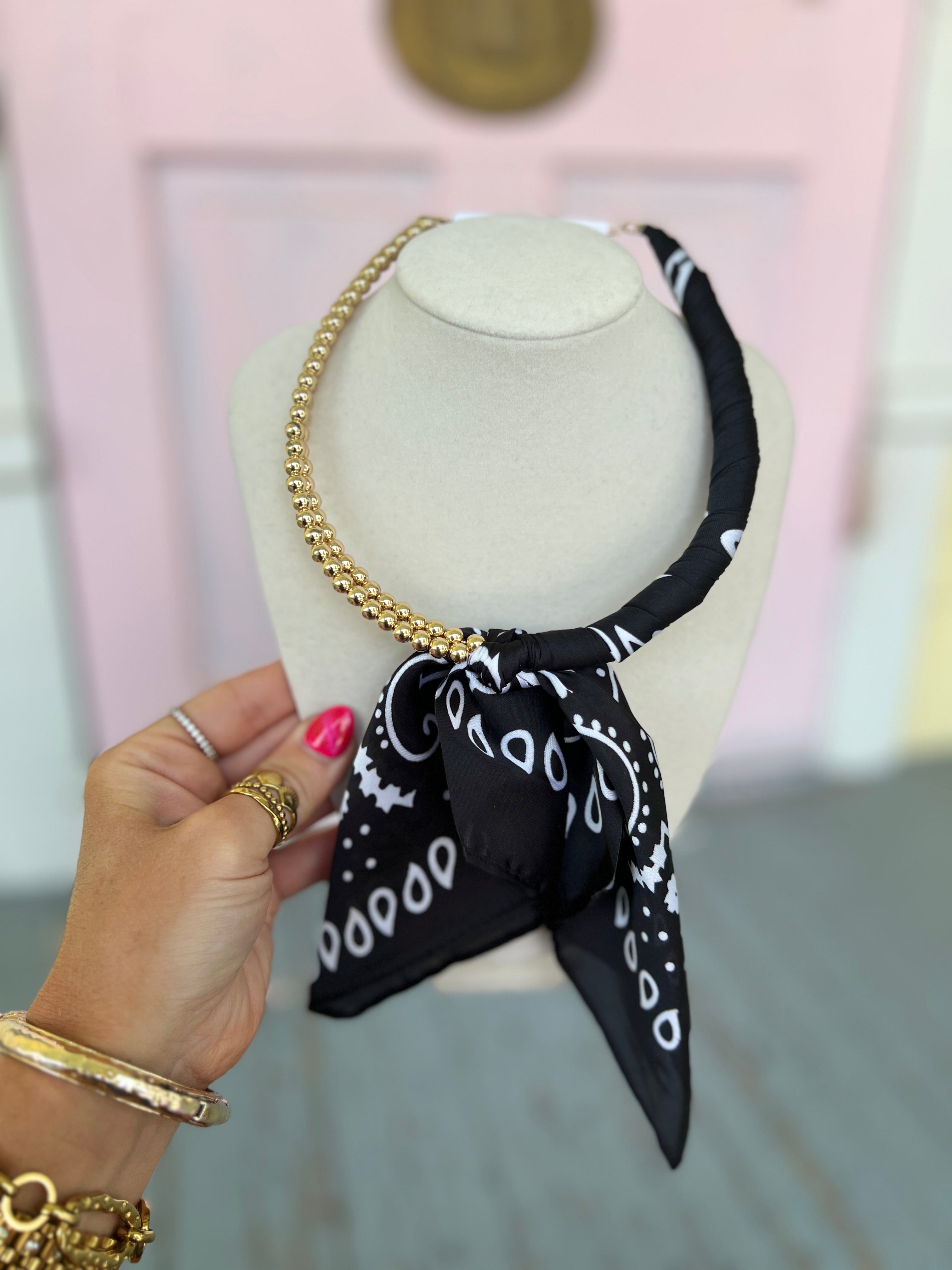 Black scarf-wrapped collar necklace with gold chain and bow detail