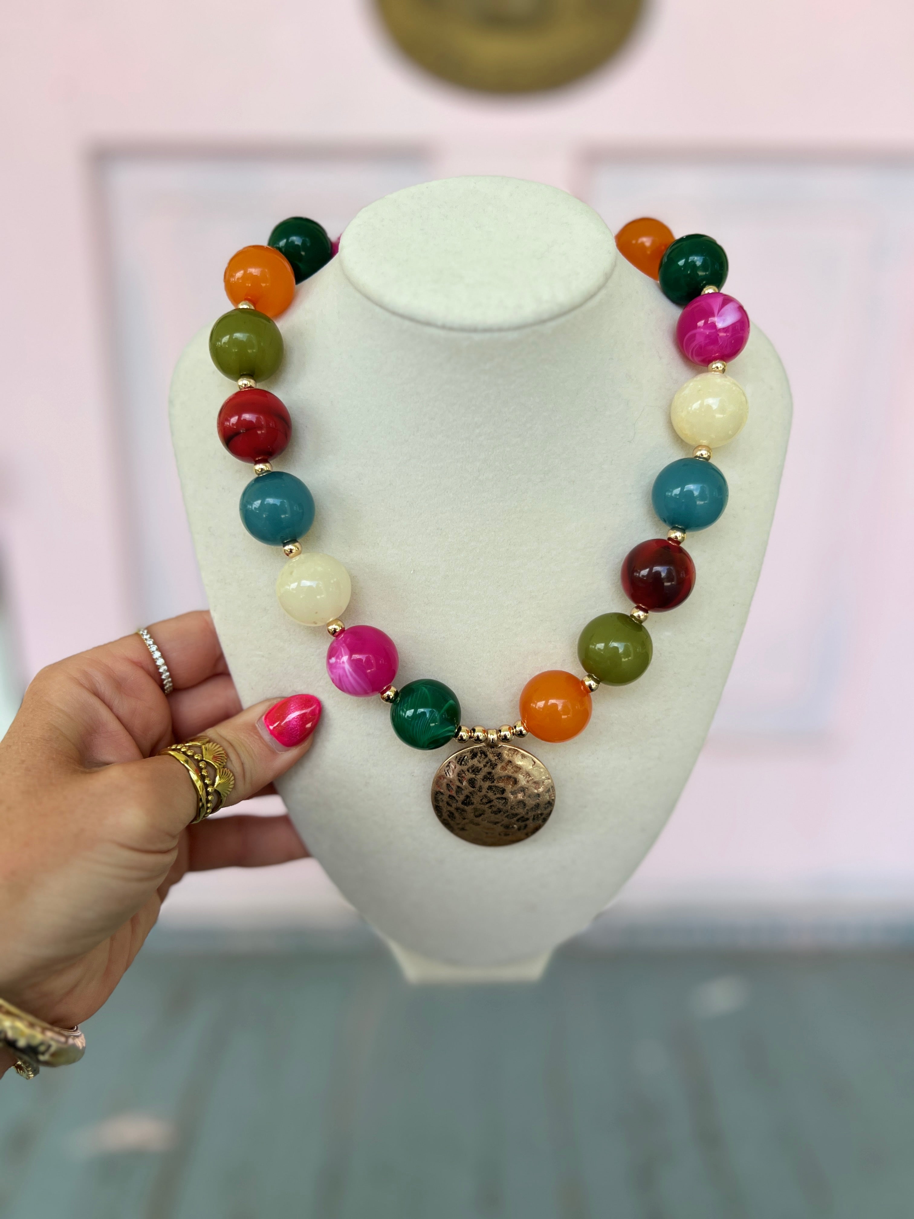 Multi-color bead necklace with gold-tone metal disk pendant and round clasp