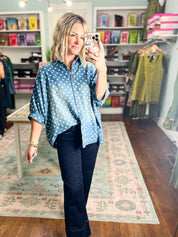 Light blue polka-dot denim button-front shirt with collar and short sleeves
