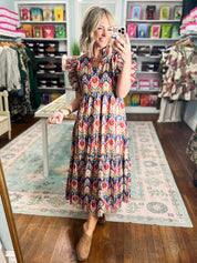 Multicolor tiered midi dress with geometric print and short ruffled sleeves, standing