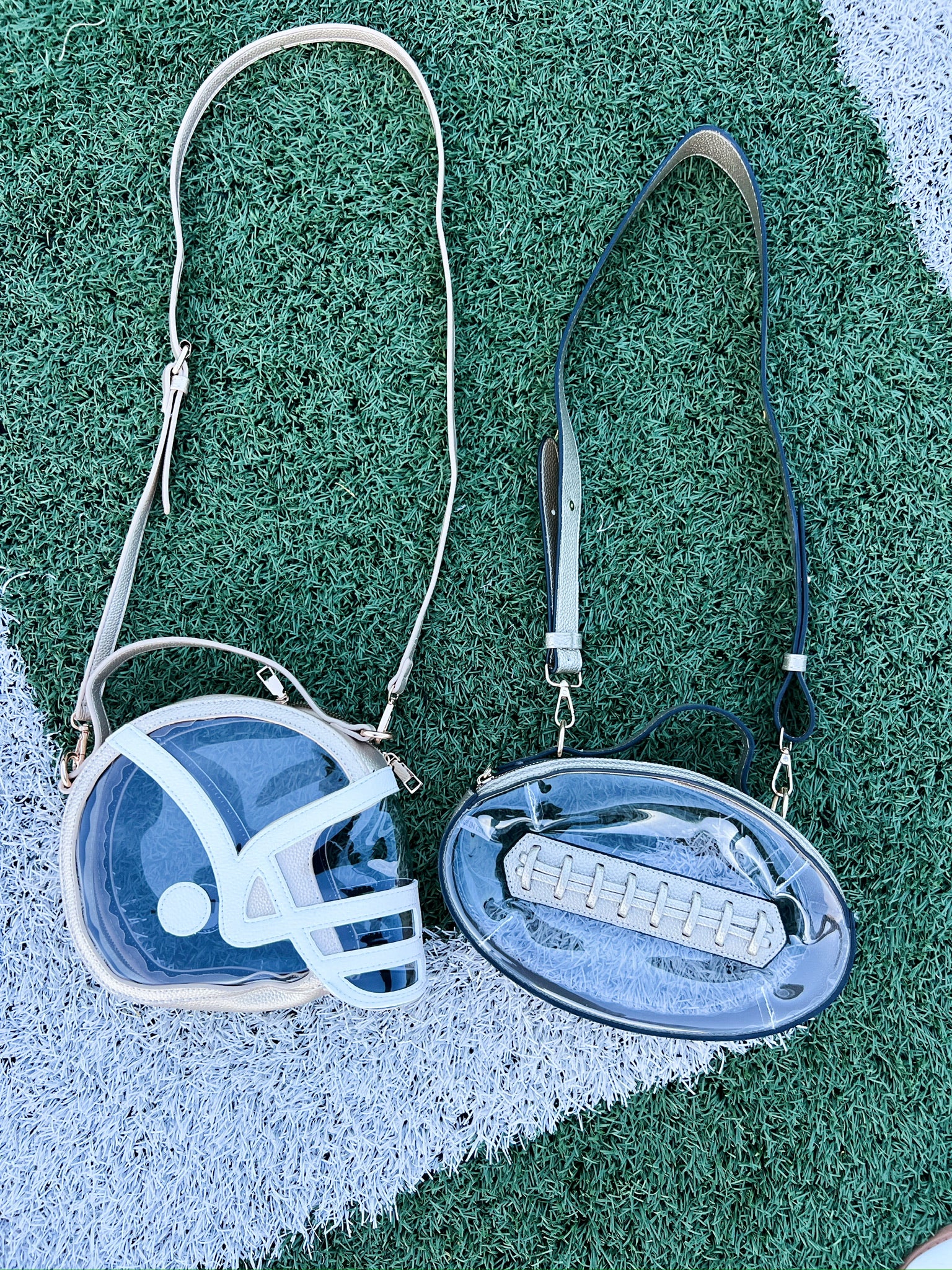 Helmet-shaped clear crossbody bag with white helmet graphic and shoulder strap (pair view)