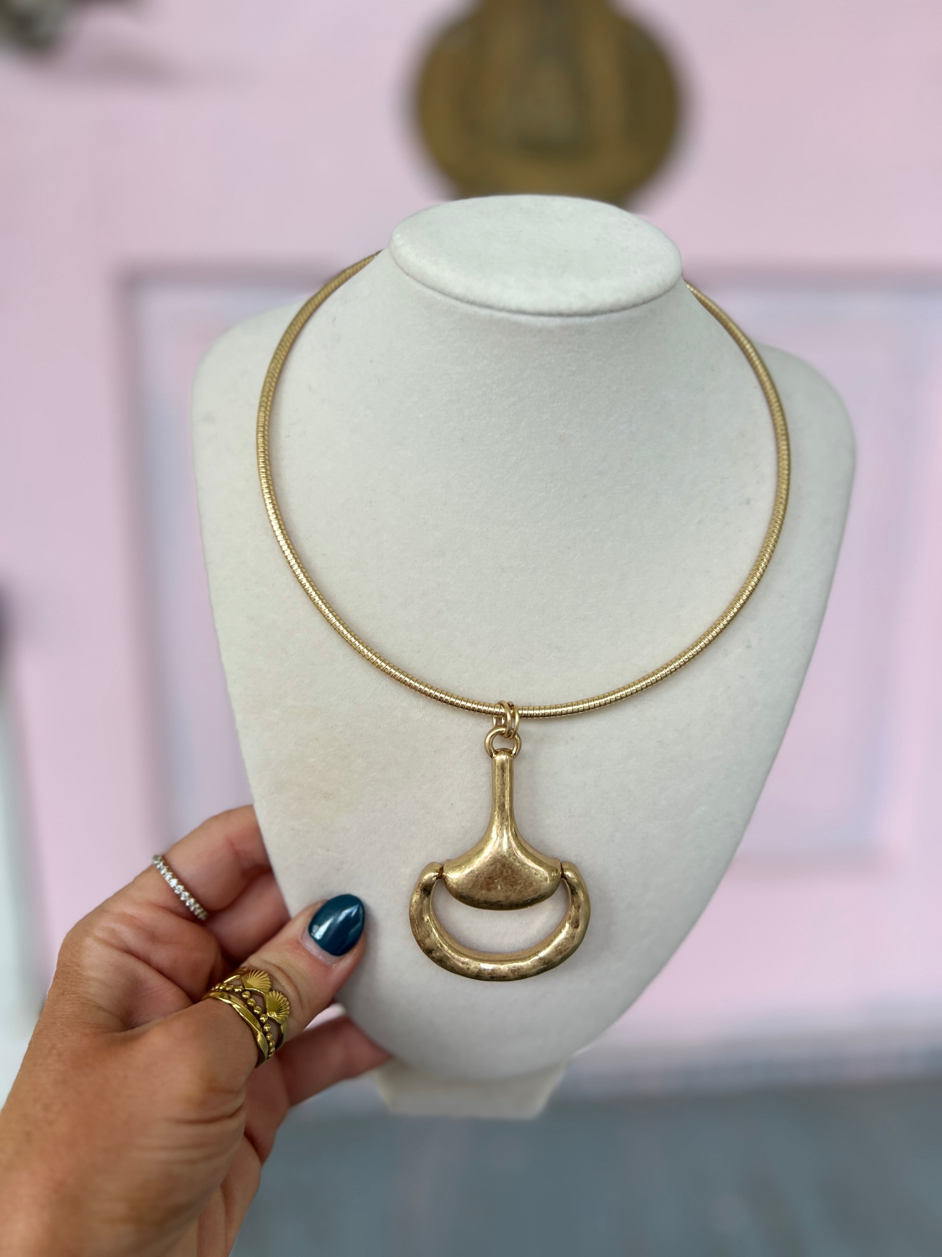 Gold choker necklace with vintage horsebit pendant detail on a slim chain