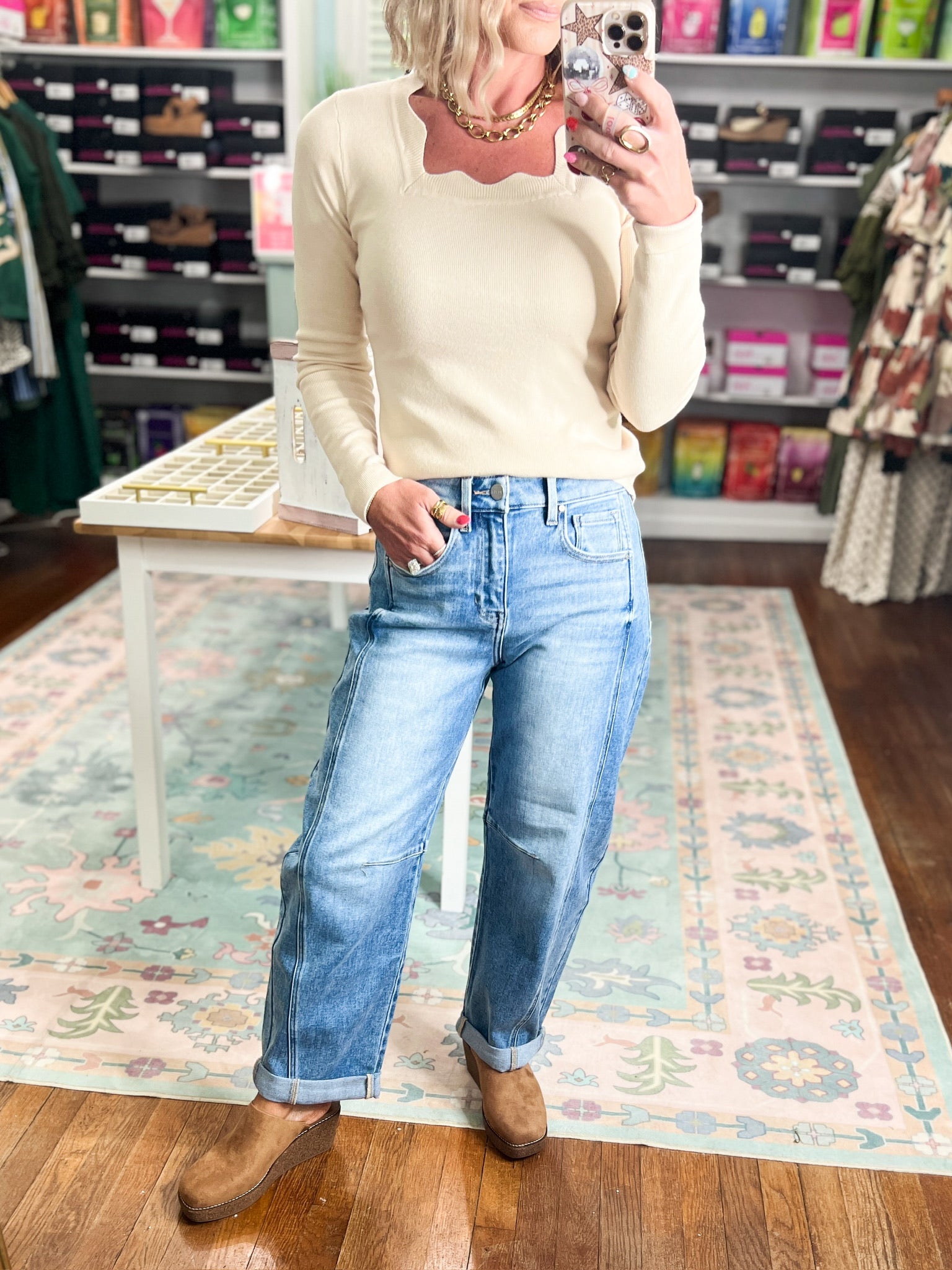 Medium-wash high-rise crop barrel jeans, cuffed hem, relaxed straight leg