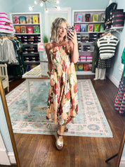 Floral pleated midi dress on model, sleeveless wide straps and square neckline