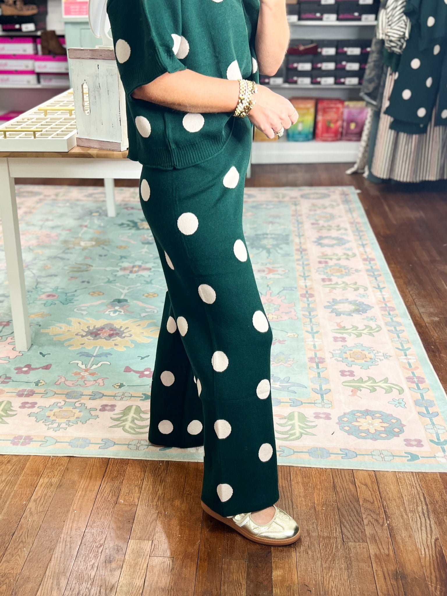 Hunter green knit wide-leg pants with white polka dots and side pockets