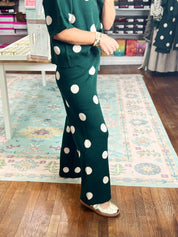 Hunter green knit wide-leg pants with white polka dots and side pockets