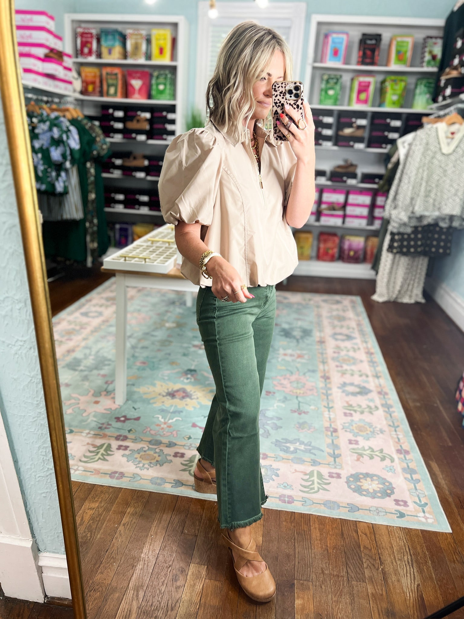 Light taupe puff-sleeve blouse with stand collar and front zipper, side view