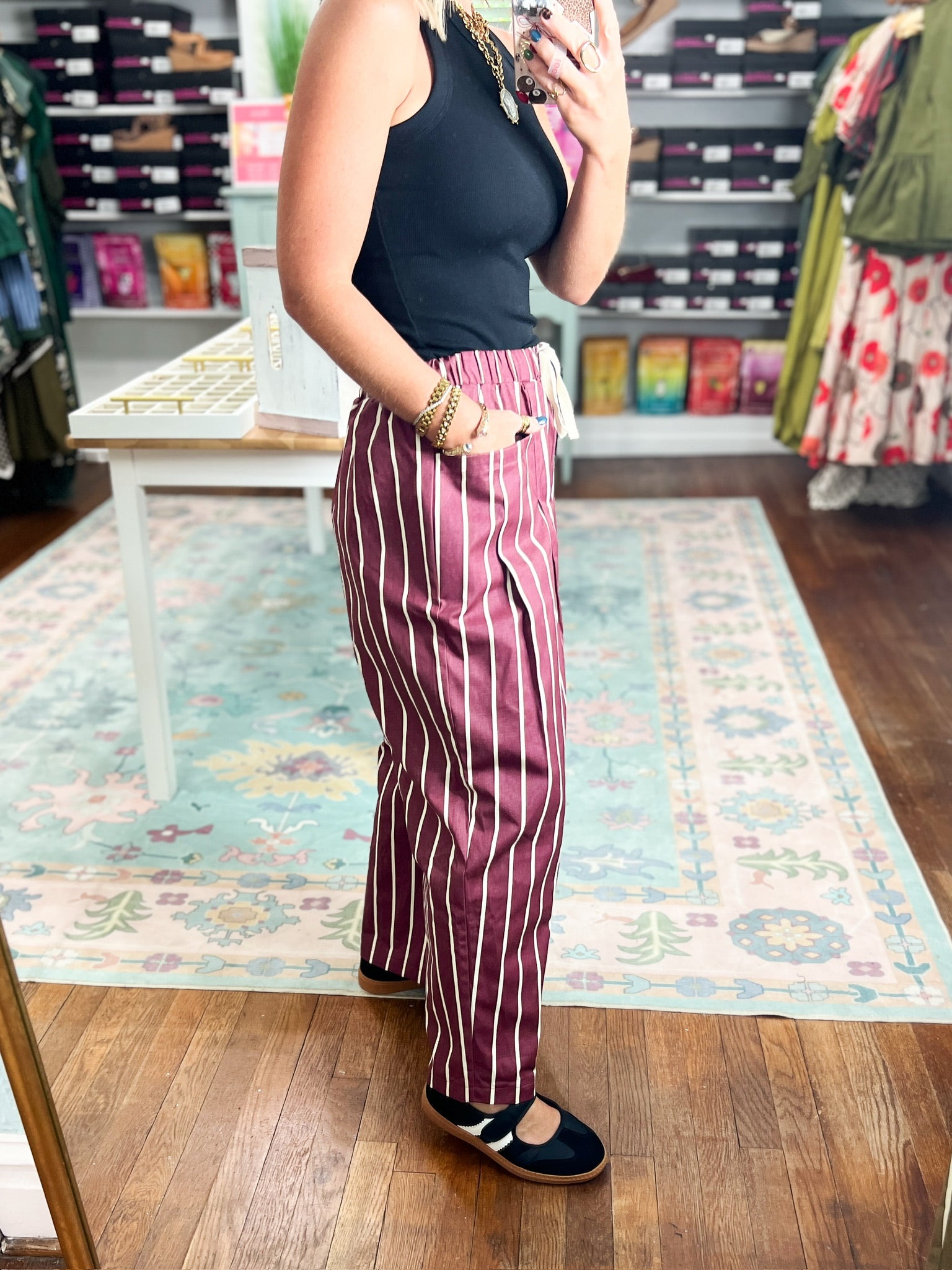Burgundy striped wide-leg pants with elastic waistband and side pockets, full view