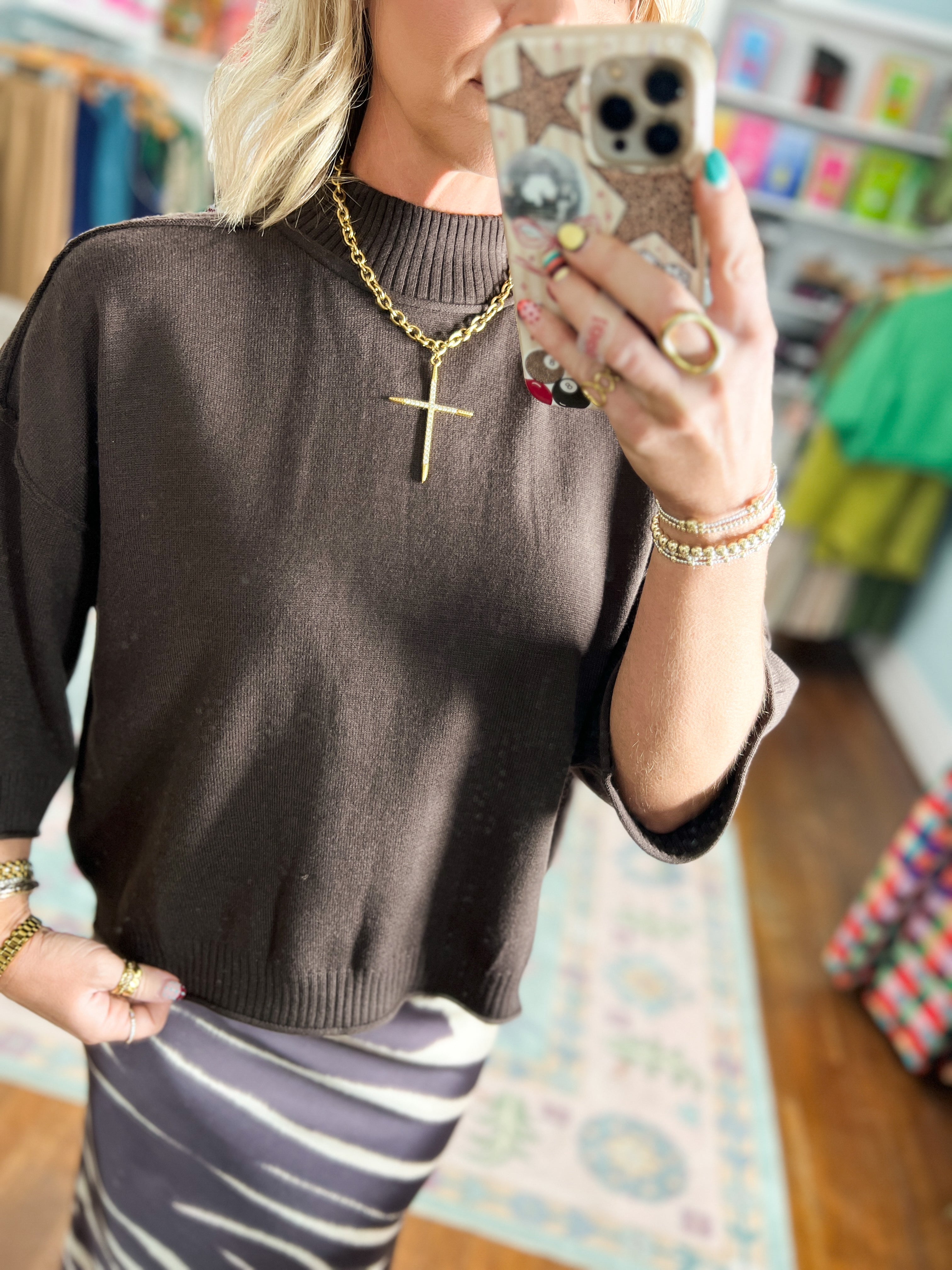 Brown mock neck knit pullover with ribbed neckline and cuffs, loose fit