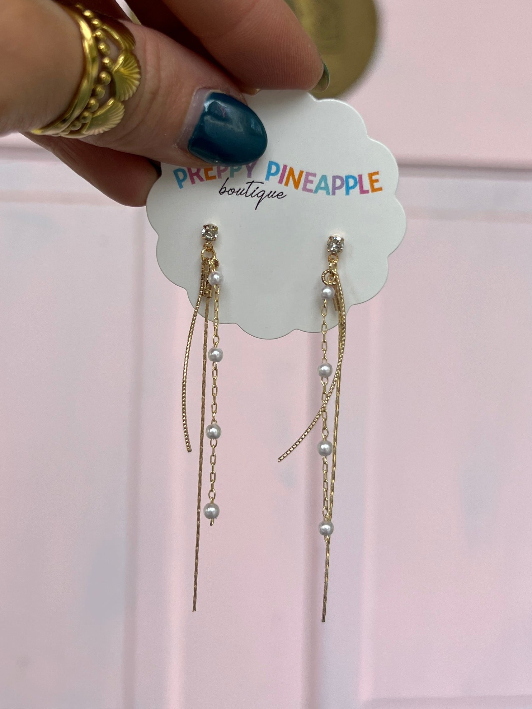 Layered wire pearl earrings with gold-tone drops and small stud tops
