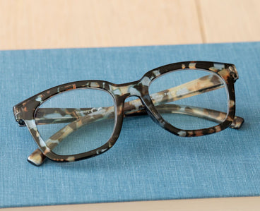 Tortoiseshell eyeglasses with blue temple details and clear lenses