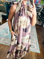 Sleeveless mauve midi dress close-up with floral print, ruffled neckline and gathered hem