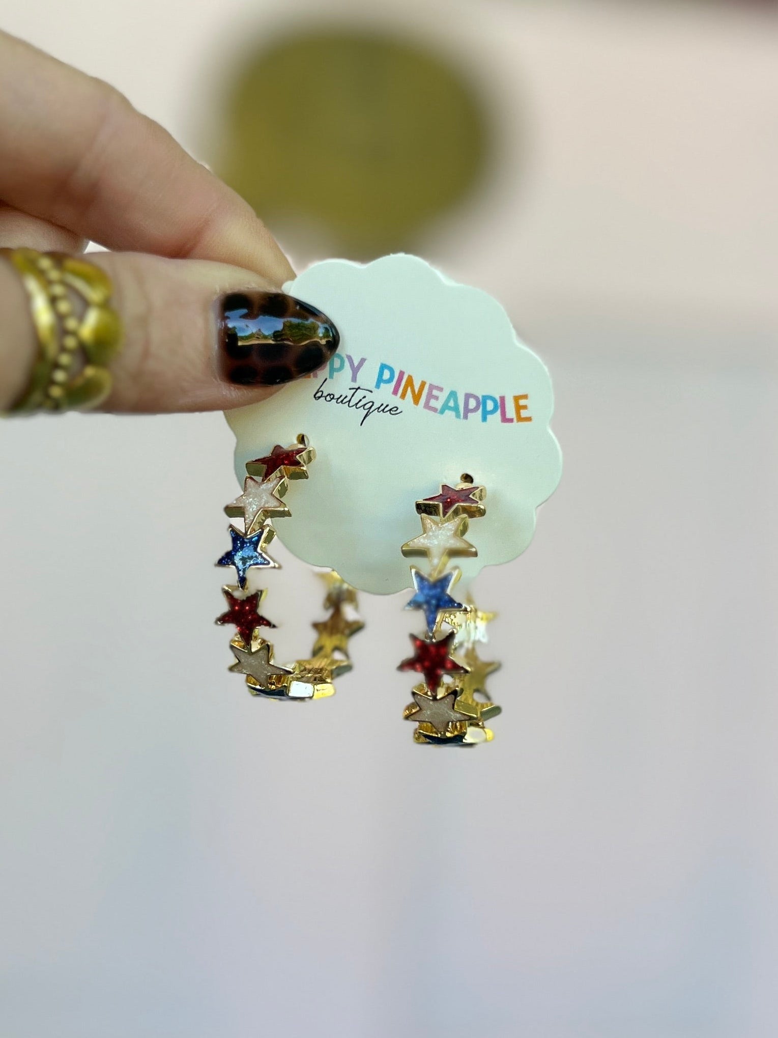 Star drop hoop earrings with red, blue, and white epoxy stars, gold-tone