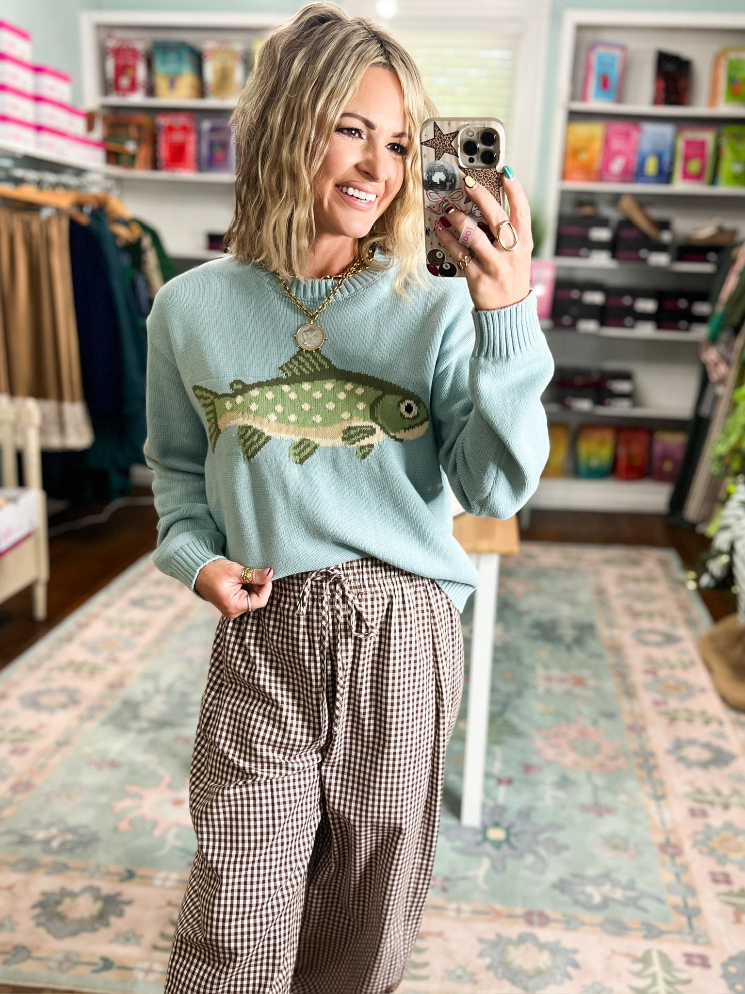 Sage crewneck sweater with a dotted fish design and ribbed trim