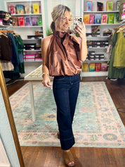 Brown draped sleeveless satin top with gathered shoulder ruffle, front view