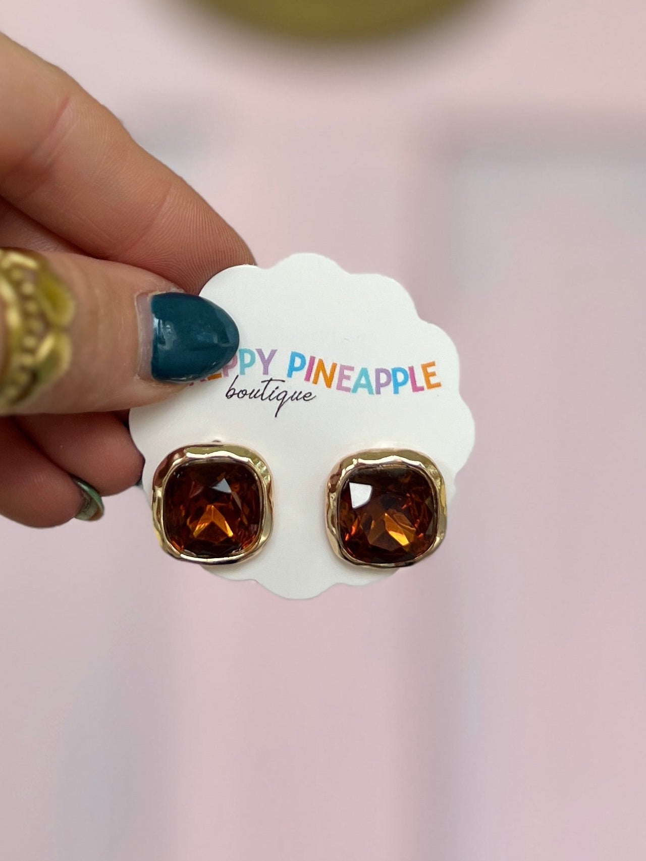 Framed square topaz stone earrings with warm amber centers and gold-tone settings