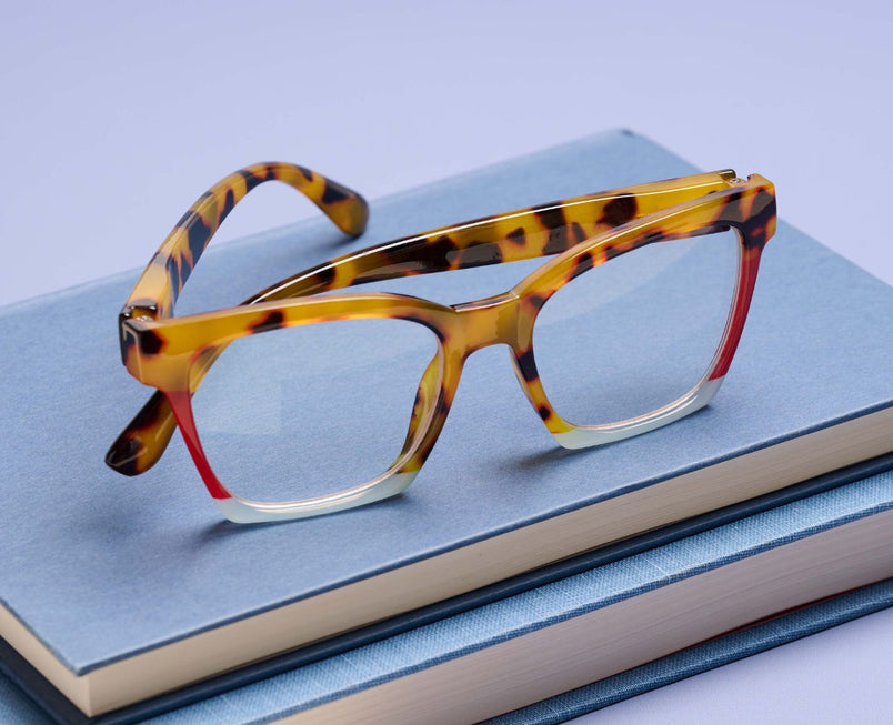 Tortoise colorblock eyeglass frames with clear lenses and red-tinted inner arms
