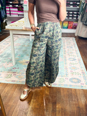 Green camo relaxed-fit pants with elastic waist and flowy wide legs, ankle length
