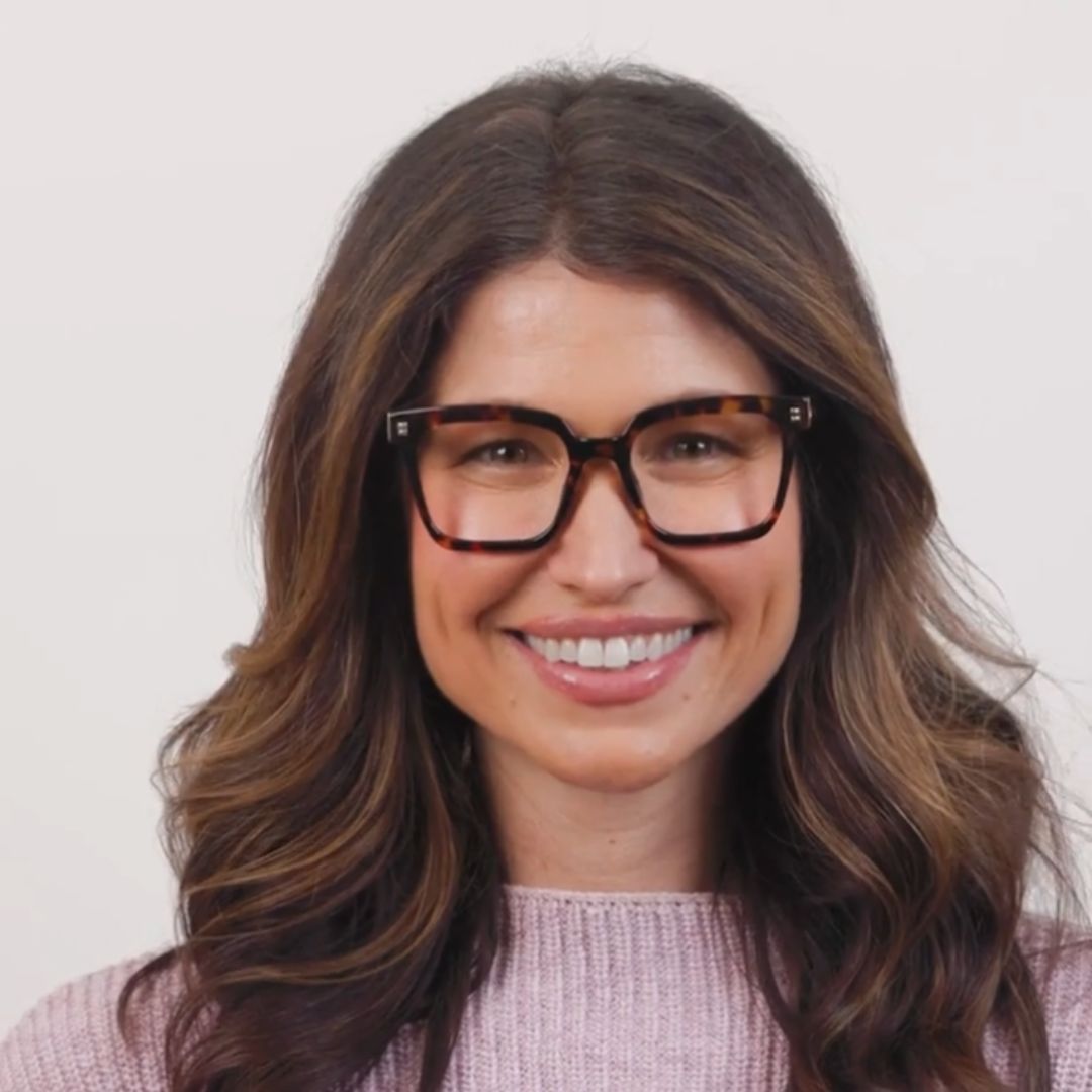 Tortoise eyeglasses on a smiling woman, dark frame with rectangular lenses