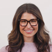 Tortoise eyeglasses on a smiling woman, dark frame with rectangular lenses