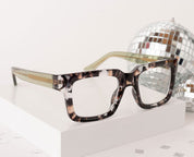 Rectangular tortoise eyeglasses with green temples and dark bridge detail