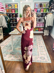 Burgundy strapless maxi dress with oversized cream and pink floral print, fitted silhouette
