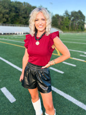 Crimson flutter sleeve top with round neckline and puffed shoulders