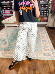 Ivory dot wide-leg pants with relaxed drape and gathered elastic waist