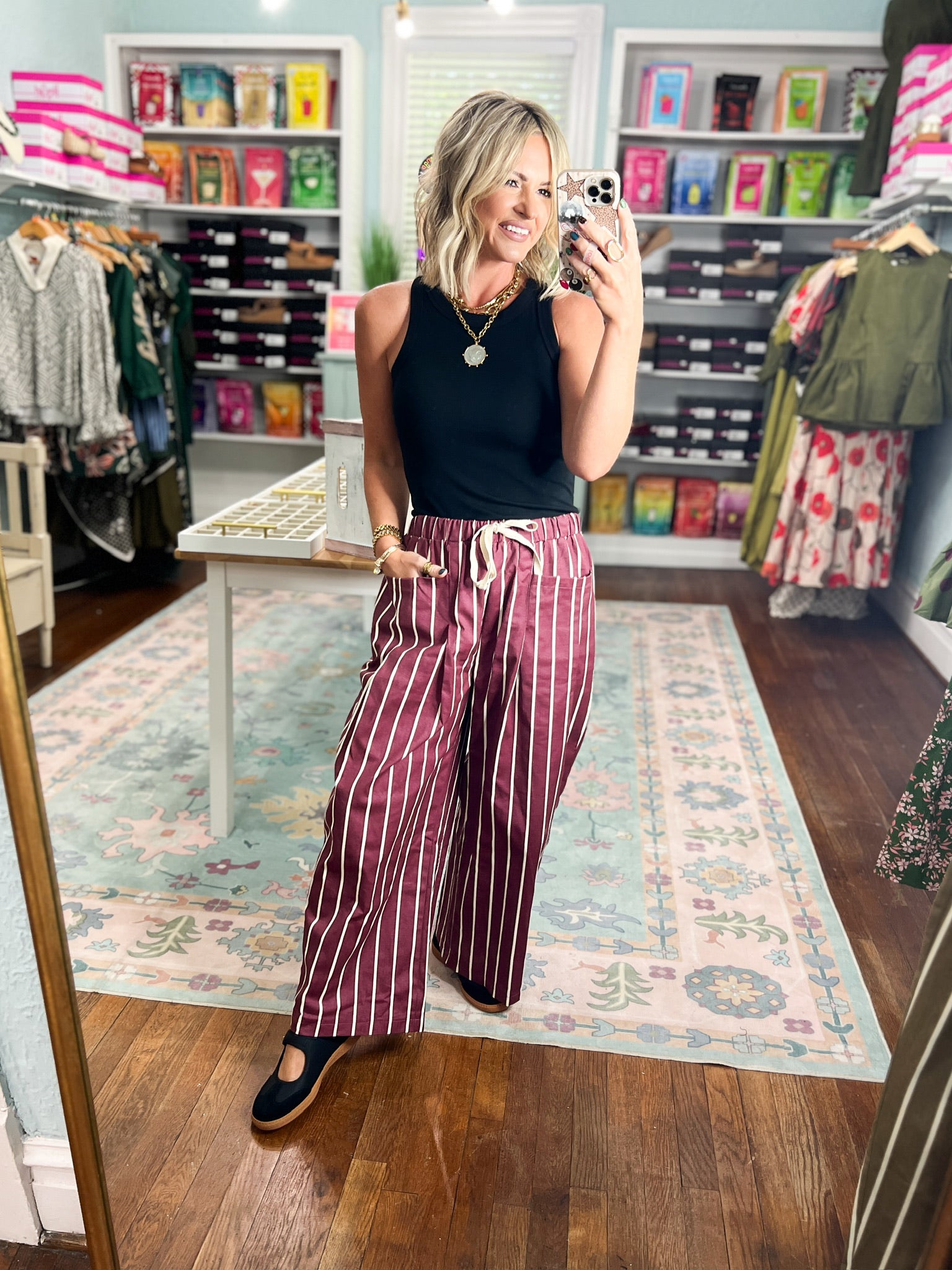 Burgundy striped wide-pocket pants with white vertical stripes and relaxed wide legs