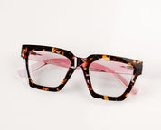 Peepers progressive reading eyeglasses, tortoiseshell frame with pink-tinted lenses, angled view