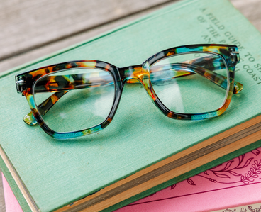 Close-up progressive glasses with tortoise frame and blue-green eyeglass lenses