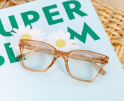 Peepers tan translucent eyeglass frames with gold-tone temples, close-up