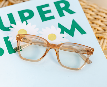 Peepers tan translucent eyeglass frames with gold-tone temples, close-up