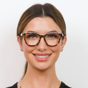 Tortoise eyeglasses on face with clear lenses and teal-accent temples