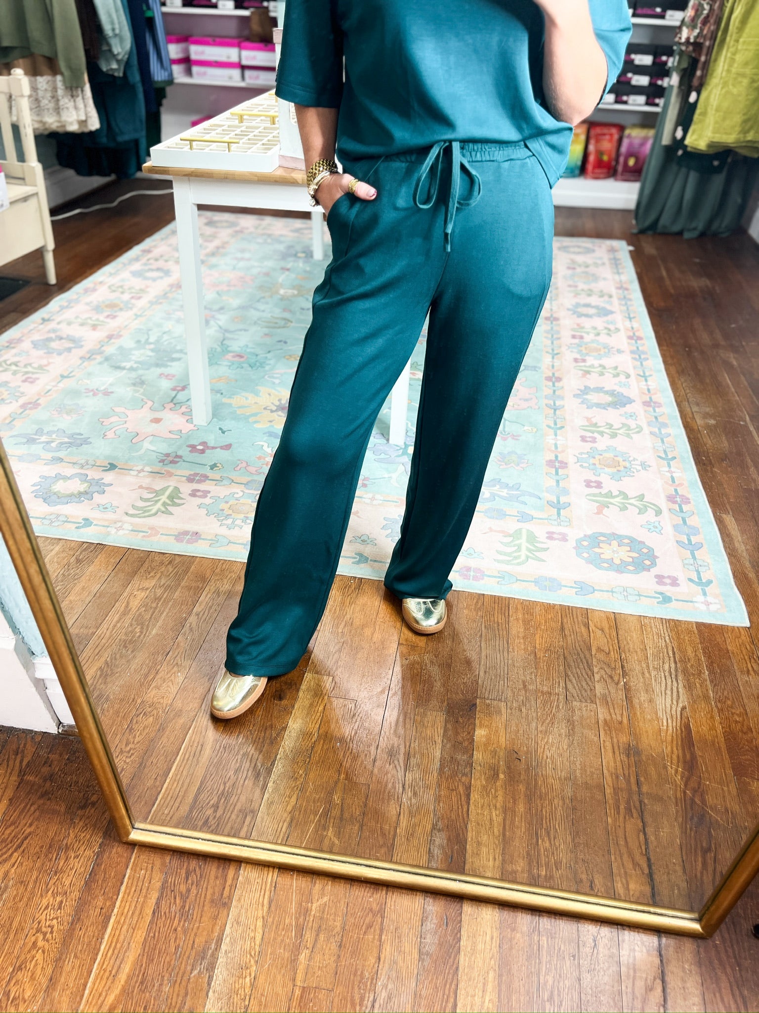 Deep green elastic-waist straight-leg pants with drawstring, full side view