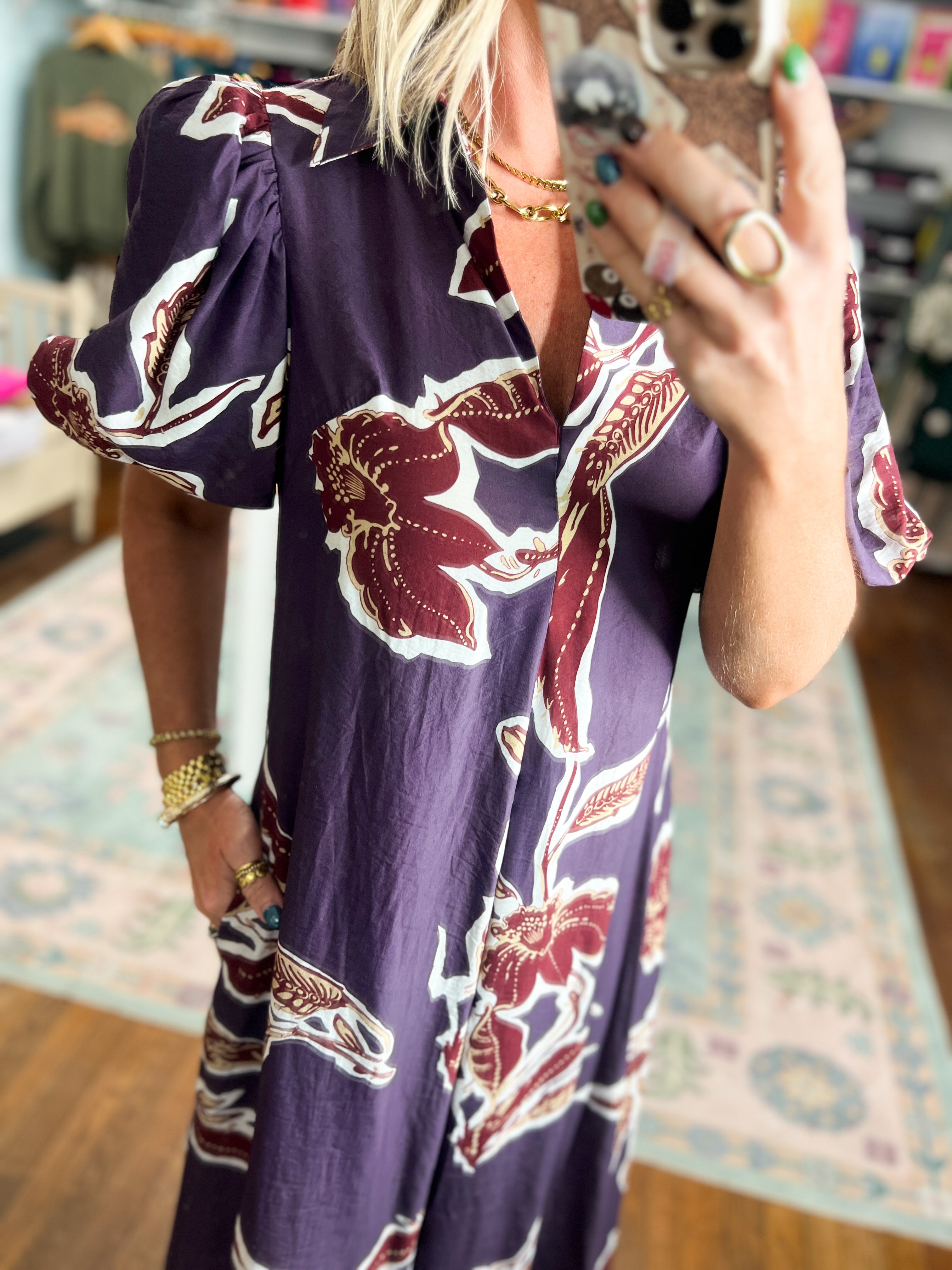 Dark purple puff-sleeve dress with maroon floral print and gathered shoulder detail