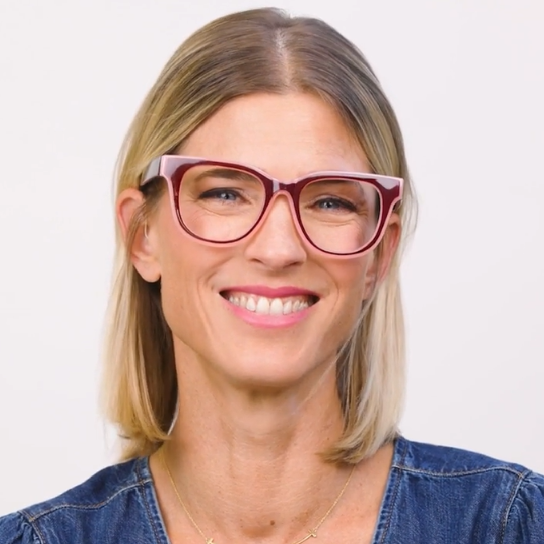 Progressive eyeglasses on a person, cherry frames with pink inner edges