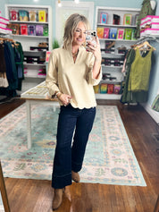 Champagne faux suede top with V-neck and scalloped hem, front view with long sleeves.