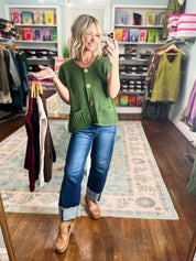 Army green ribbed knit sweater with short sleeves, gold buttons, and front patch pockets