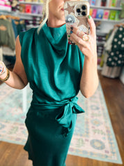 Teal sleeveless midi dress with cowl neckline and knot-tie waist detail.