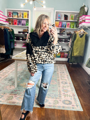 Leopard-print pullover, front view with dark button collar and long sleeves