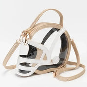 Helmet-shaped clear crossbody bag with beige straps and gold-tone hardware